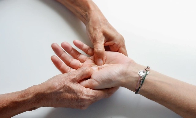 Terapis melakukan massage tangan yang lembut untuk mengurangi kekakuan otot dan meningkatkan sirkulasi darah